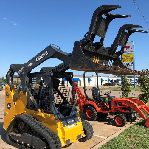 A John Deere skid steer in the Stellar Rentals Texas parking lot.