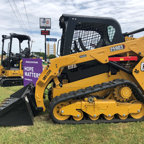 A John Deere skidsteer in the Stellar Rentals Texas parking lot.