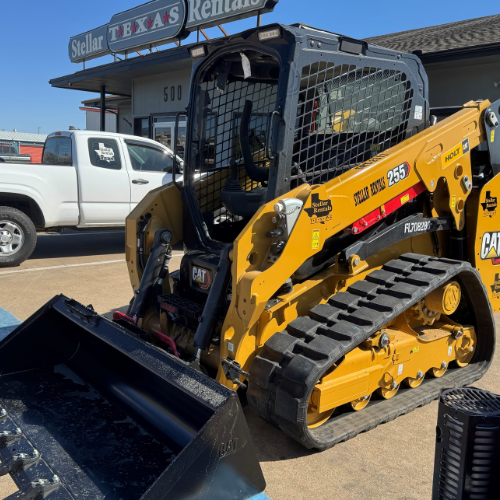 A John Deere skidsteer in the Stellar Rentals Texas parking lot.