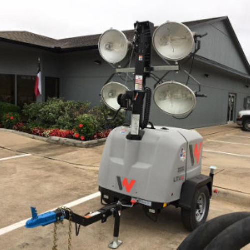 Stadium lights parked in a parking lot