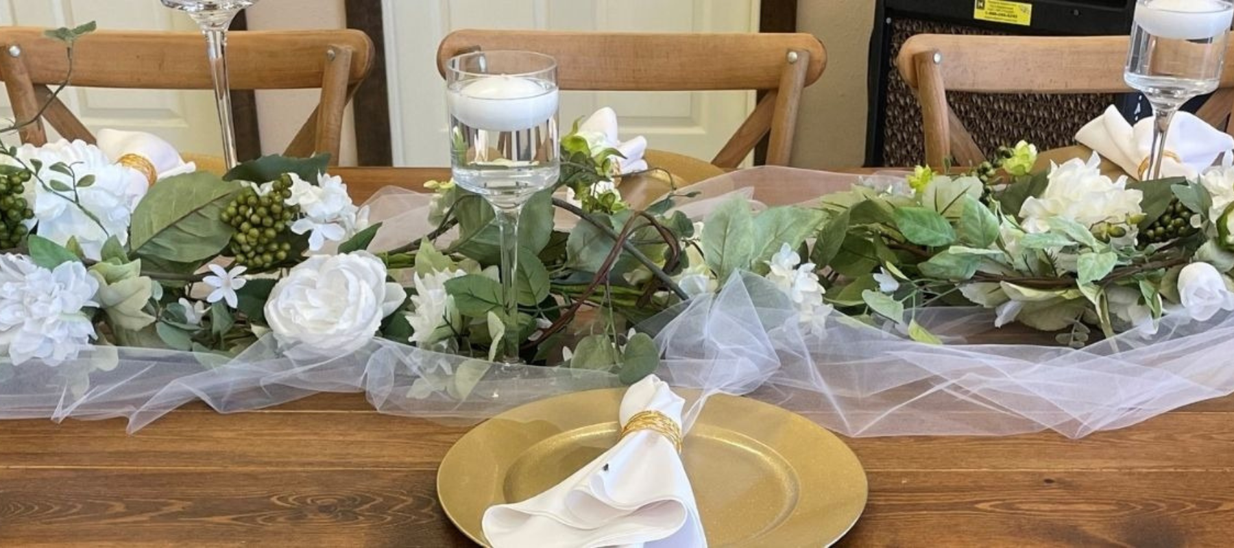 A banquet table filled with flower bouquets and glassware